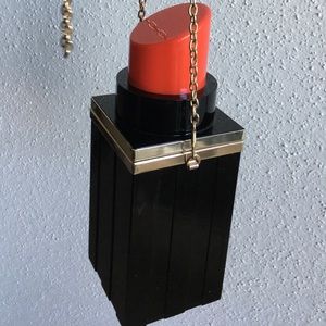 Black and red lipstick shape clutch.